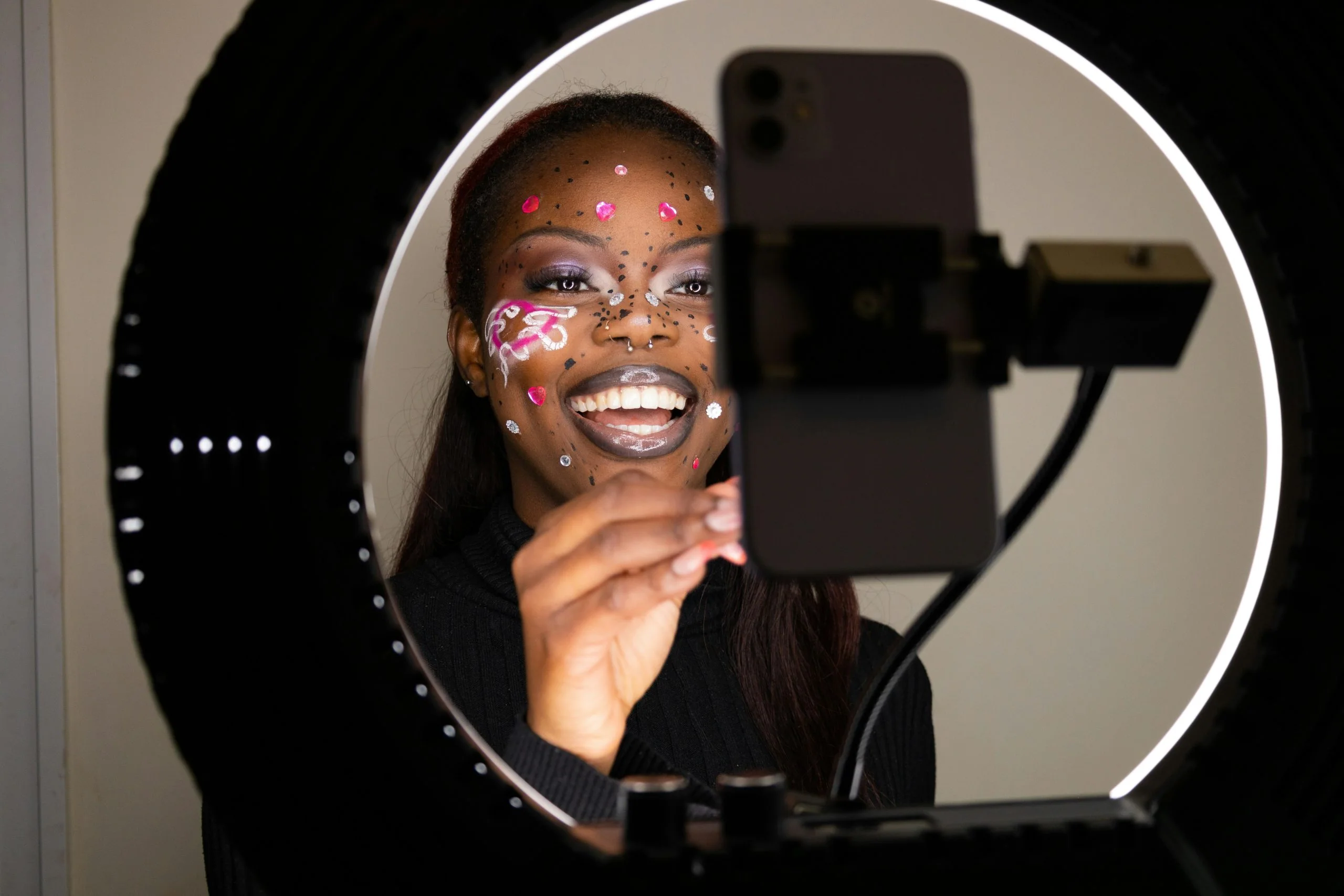 young black woman making video content with a ring light
